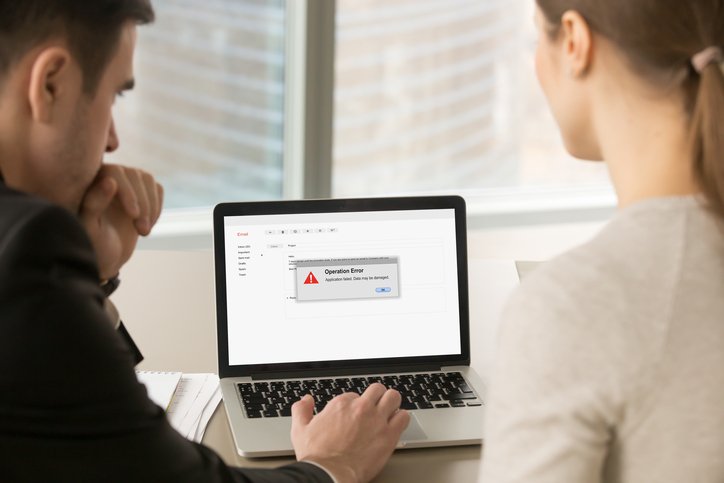 two people staring at computer